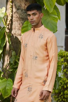 Rose gold kurta featuring stitch embroidered lily motifs. Comes with salwar.
Components: 2
Pattern: Embroidered
Type Of Work: Floral
Neckline: Mandarin Collar
Sleeve Type: Full
Fabric: Cotton Silk Tussar
Color: Gold,Pink
Other Details: 
Straight silhouette
Closure: Kurta: Front placket
Occasion: Mehendi and Puja,Sangeet - Aza Fashions Salwar For Men, Embroidered Lily, Men Kurta, Fashion App, Buy Gold, Gold Floral, Mandarin Collar, Aza Fashion, Cotton Silk