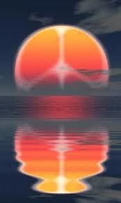 an orange and red ball floating on top of water with the sun in the background