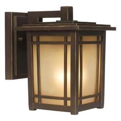 an outdoor wall light with a glass shade