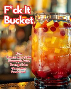 a glass filled with fruit sitting on top of a table