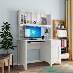 a white computer desk with a monitor and keyboard