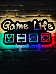 the game life logo is lit up on a brick wall with colorful lights behind it