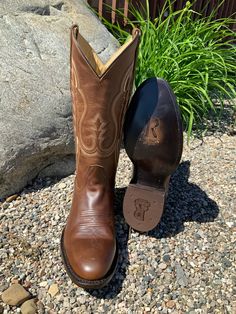 This classic brown western cowboy boot by R. Watson completes the perfect look for any occasion. R. Watson presents these brown bay apache cowhide western boots. These boots have a double row stitch pattern, R. Watson comfort system, all leather stacked heel, counters, solid steel shank, and 10 iron outsole and are 13″ total in height. Medium Round Toe Brown Bay Apache Cowhide Leather 13" Height Double-Row Stitching R. Watson Comfort System 10 Iron Outsole Leather Stacked Western Heel Rubber Hee Goodyear Welted Moc Toe Moto Boots For Ranch, Western Moc Toe Boots With Leather Sole, Western Style Square Toe Boots For Western-themed Events, Goodyear Welted Moc Toe Boots For Rodeo, Brown Moc Toe Moto Boots For Ranch, Western Moto Boots With Goodyear Welted Construction, Western Moto Boots With Goodyear Welt, Western Style Moto Boots With Goodyear Welted Construction, Western Style Moto Boots With Goodyear Welt