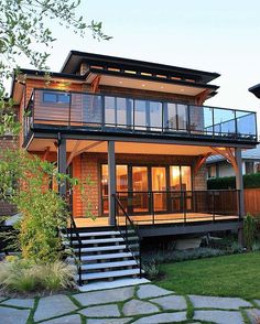 a house with a deck and stairs leading up to it