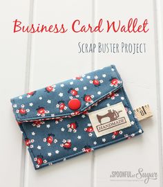 the business card wallet is blue with red and white flowers on it, along with a name tag that says scrap buster project