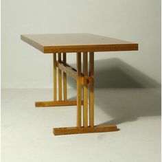 a wooden table sitting on top of a white floor