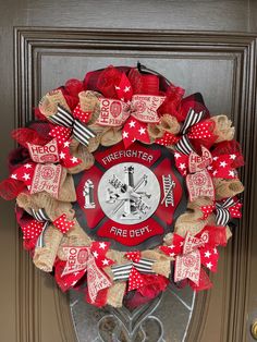 a fire department wreath on a door with red, white and black ribbon around it