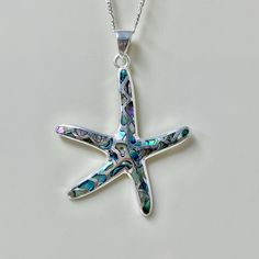 Measurement in Charm:  Weight:  42cts / 8.4g size: 46.5x42x3mm Metal component: 925 Sterling Sliver Gemstone in charms: Abalone Shell Quantity: 1 pieces 100% Genuine & Natural Our Sterling Silver Starfish Pendant Necklace features a stunning Abalone shell or Mother of Pearl inlay. This exquisite piece combines the elegance of sterling silver with the shimmering beauty of the ocean, creating a captivating and stylish accessory. Packages with below: 1. A charm with gift bag 2. Sliver polishing clo Sterling Silver Shell Pendant Necklace As Gift, Silver Mother Of Pearl Shell Necklace As Gift, Silver Abalone Shell Necklace Gift, Silver Pendant Shell Necklace Gift, Silver Shell Pendant Necklace For Gift, Silver Sterling Silver Shell Pendant Necklace, Silver Sterling Silver Pendant Shell Necklace, Silver Abalone Shell Pendant Necklace, Silver Round Shell Necklace For Gifts