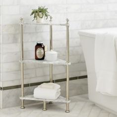 a bathroom with a white bath tub and marble tile flooring next to a shelving unit