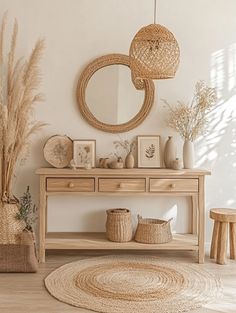 a table with baskets and vases on top of it next to a round mirror