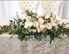 an arrangement of white flowers on a table