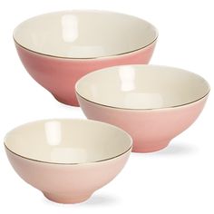 three pink bowls with white rims are sitting side by side on a white background