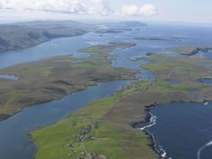 an aerial view of some water and land