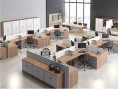 an office cubicle with multiple desks and cabinets in the middle of it,