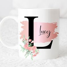 a white coffee mug with pink flowers and the letter j on it's side