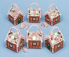 six christmas baskets with candy canes and candies in them on a blue background