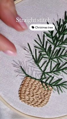 someone is stitching a pine tree in a basket