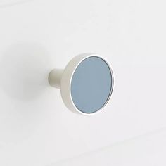 a white door knob with a blue mirror on it