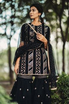 Shop for Kaia Black Cotton Embroidered Kurta Sharara Set for Women Online at Aza Fashions Black Palazzo Set With Mirror Work For Festivals, Black Sharara With Gota Work For Festivals, Black Palazzo Set With Mirror Work For Navratri, Black Sharara With Gota Work For Eid, Black Palazzo Set With Gota Work, Black Bollywood Sharara With Gota Work, Eid Black Sharara With Gota Work, Black Palazzo Set With Gota Work For Festive Occasions, Black Palazzo Set With Gota Work For Eid