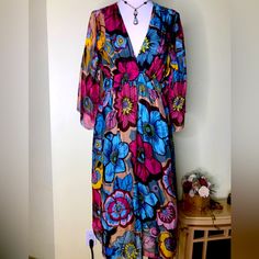 Beautiful Silk/Rayon Dress. Made In Italy I Didn’t Know It Was Part Rayon At All Because The Dress And Lining Feel Like Silk. Gorgeous Floral Blue And Pink On Gold Background. Empire Waist. Flows Like A Dream. Size Large. Elastic Waist Makes It Very Adjustable. Never Worn New With Tags. Colorful Floral Print V-neck Dress, Pink Vibrant Print Dress For Beach Cover-up, Flowy Floral Print Midi Dress Beach Cover-up, Colorful V-neck Dress For Day Out, Chic Multicolor Maxi Dress For Daywear, Multicolor Long Sleeve Midi Dress For Daywear, Multicolor V-neck Midi Dress For Beach Cover-up, Colorful V-neck Maxi Dress For Beach Cover-up, Colorful Floral Print V-neck Maxi Dress