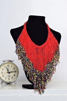 Traditional Multicolor Beaded Fringe Necklaces, Traditional Multicolor Beaded Necklaces With Fringe, Traditional Multicolor Beaded Necklace With Fringe, Red Beaded Bohemian Bib Necklaces, Festival Round Beaded Fringe, Red Bohemian Bib Necklace For Festivals, Bohemian Red Bib Necklace With Round Beads, Bohemian Multicolor Beaded Fringe Necklace, Bohemian Multicolor Bib Necklace With Polished Beads