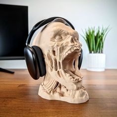 headphones on top of a sculpture of a demon