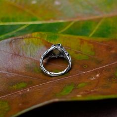 "Labradorite ring \"Daisy\" is created from Sterling Silver absolutely by hands and features a beautiful green-blue Labradorite cabochon in the center. Design of the ring is inspired by Mother nature. The master made tree brunch texture and have added few leaves and flowers. It can be a choice if you are looking for a gentle Labradorite engagement ring. Enjoy the finer details and glow of the magnificent and powerful Labradorite! DETAILS - 925 Sterling Silver - Oxidized antique finishing - Amazi Nature-inspired Moonstone Wedding Ring, Handmade Nature-inspired Moonstone Ring For Wedding, Nature-inspired Handmade Moonstone Ring For Anniversary, Handmade Nature-inspired Moonstone Ring For Anniversary, Nature-inspired Moonstone Ring, Nature-inspired Rings With Rose Cut Diamonds As Gift, Nature-inspired Rings With Rose Cut Diamonds For Gift, Nature-inspired Solitaire Rings For Gifts, Nature-inspired Rings With Rose Cut Diamonds