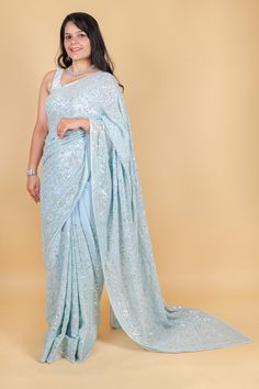 Take elegance to the next level with our stunning Georgette saree in a magnificent shade of blue. Adorned with delicate sequins, this saree exudes sophistication and luxury. Perfect for special occasions or to add a touch of glamour to your everyday look. Elevate your style with this exquisite saree. Georgette saree with sequins - Blue Saree comes with a blouse piece. Fall and pico done. Fully stitched blouse shown in pictures is optional and can be purchased seperately from our blouses and croptops section. For saree video please connect with us on whatsapp @469-937-0606 Ready to be shipped in USA from San Diego, California. All pictures are original pictures. Colors may slightly vary due to pic resolution. Semi-stitched Sequined Pre-draped Saree For Reception, Bollywood Style Pre-draped Saree With Sequins, Sequin Pre-draped Chinon Saree, Sequin Chinon Pre-draped Saree For Diwali, Blue Georgette Pre-draped Saree With Self Design, Blue Sharara With Sequins For Reception, Blue Sequined Sharara For Reception, Glamorous Saree With Resham Embroidery In Traditional Drape, Glamorous Resham Embroidery Saree In Traditional Drape