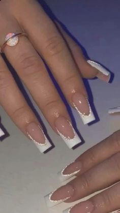 a woman's nails with white glitter on them