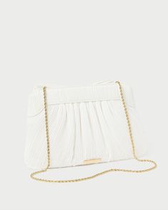 Pleated frame clutch in bright white shantung topped with our signature knotted bow. Features a removable twisted gold chain crossbody strap, frame closure, full lining, and gold stamped logo. White Evening Bag With Gold-tone Hardware, White Clutch With Gold-tone Hardware For Evening, Chic White Clutch Evening Bag, Chic Wedding Clutch With Gold-tone Hardware, Chic White Evening Bag, White Clutch Evening Bag With Chain Strap, Classic White Evening Bag With Gold-tone Hardware, Textured Evening Bag, White Luxury Evening Bag