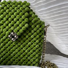 Explore unique style with the Irregular Green Bag, featuring an unconventional design crafted from soft green velvet beads and lined with luxurious fabric. This handmade accessory offers a fresh, artistic twist on elegance, perfect for those who appreciate individuality in their fashion. Green Shoulder Bag For Spring, Green Shoulder Bag For Spring Fashion, Elegant Green Bag, Summer Formal Green Bags, Spring Green Shoulder Bag For Party, Green Shoulder Bag For Spring Party, Green Shoulder Bag For Summer Parties, Green Summer Party Shoulder Bag, Elegant Spring Beaded Shoulder Bag