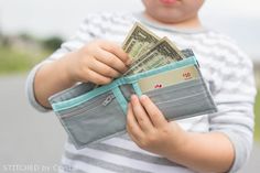 a little boy holding money in his pocket