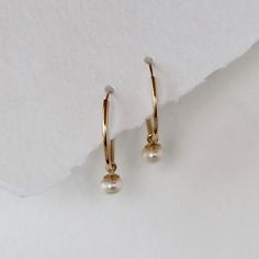 Endless hoops in solid 14k yellow gold are accented with white cultured pearl dangles. The hoops are 15mm in diameter and the cultured pearls are 4mm each. This is not gold filled metal, this is solid 14k gold. A cultured pearl is a genuine pearl, produced by an oyster or mollusk with human assistance. Endless hoops open with a little tension, and you slip the post through your ear and use a little tension to put the post back into the hoop. The pearl dangle can be slipped on and off, creating t White Teardrop 14k Gold Hoop Earrings, Dainty Yellow Gold Hoop Earrings With Pearl, 14k Gold Hoop Pearl Drop Earrings, Delicate Yellow Gold Hoop Pearl Earrings, Everyday 14k Gold Hoop Earrings With Pearl Charm, Classic Dangle Hoop Earrings With Pearl Charm, Classic Pearl Charm Huggie Earrings For Anniversary, 14k Gold Pearl Charm Huggie Earrings, 14k Gold Hoop Earrings With Pearl Drop For Weddings