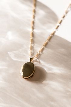 Our take on the classic locket necklace. Our Oval Locket Necklace is lightweight and great for layering! You can store two photos in the locket - whether it's your significant other, mom, dog, etc. - whatever is special to you! You won't want to take it off - and you won't have to! Find more at Simple & Dainty! Dainty Oval Pendant Locket Necklace For Anniversary, Classic Oval Necklace For Memorial, Heirloom Oval Pendant Locket Necklace For Memorial, Dainty Locket Necklace For Memorial, Dainty Locket Necklace For Memorials, Oval Locket Jewelry For Keepsake, Oval Locket Necklaces For Mother's Day, Oval Link Locket Jewelry For Keepsake, Oval Locket Jewelry For Everyday