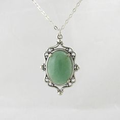 This pendant is a 20 mm x 30 mm sterling silver setting with a 18 mm x 13 mm green Aventurine, aged to resemble an heirloom piece. This perfectly matches my Aventurine ring and is a beautiful gift given as a set.   Each cameo necklace comes with a 16 inch silver chain. If you require a longer chain, please include this information at checkout. For any other custom orders or requests. All items come with free repair, resize and maintenance for the life of the product, including replacement of the Elegant Silver Aventurine Jewelry, Vintage Green Aventurine Jewelry, Handmade Vintage Aventurine Jewelry, Vintage Jewelry With Large Oval Stone Pendant, Vintage Oval Pendant Jewelry With Large Stone, Vintage Large Oval Stone Pendant Jewelry, Silver Jade Oval Pendant Jewelry, Aventurine Ring, Octopus Pendant