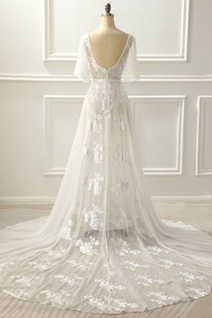 a white wedding dress with flowers on it