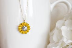 "This pendant is from my vintage garden collection, sweet adorable tiny yellow enamel daisy measures 50\" in diameter. Hangs from a new 14 karat gold filled cable chain . Spring closure clasp. The Daisy is vintage an in mint condition The model is wearing a 16\" length. H A N D M A D E * We hand make all pieces in our Water Mill New York studio * We source eco friendly packaging and materials, including recyclable mailers! FREE BOX AND WRAP ON EVERY ORDER P R O D U C T I O N ∙ T I M E S All item Gold Flower Necklace With Vintage Charm, Cute Gold Jewelry With Vintage Charm, Dainty Yellow Flower Shaped Jewelry, Vintage Gold Jewelry With Sunflower Design, Dainty Yellow Flower Necklace, Yellow Flower-shaped Enamel Jewelry, Yellow Enamel Flower Shaped Jewelry, Vintage Yellow Enamel Jewelry, Dainty Yellow Flower Pendant Jewelry