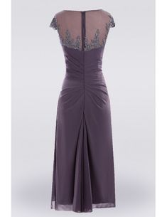 the back of a dress with sheer shoulders and beaded detailing on the neckline