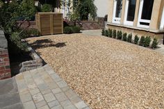 a graveled area in front of a house