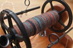 a spool of yarn sitting on top of a spinning wheel