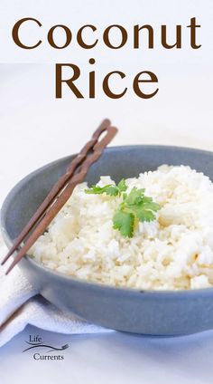 coconut rice in a blue bowl with chopsticks next to it on a white tablecloth