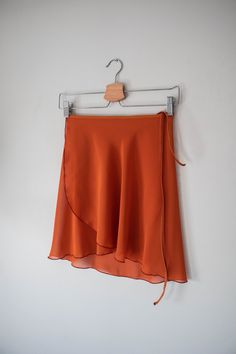 Ready for Ballet Class? Our classic, pumpkin spice orange -colored wrap ballet skirt is exactly made for that! This ballet dress is handmade with a stretchy black nylon waist tie for a comfortable experience. Crafted 100% out of polyester chiffon with a right above the knee design for a vintage look. ✷ Perfect for Recital ✷ This orange ballet dress is the perfect choice for a vintage/classy-style recital. A conservative style with a right above the knee design for a formal performance. Not only Conservative Style, Ballet Wrap Skirt, Short Wrap Skirt, Long Wrap Skirt, Conservative Fashion, Orange Chiffon, Ballet Clothes, Orange Skirt, Ballet Class