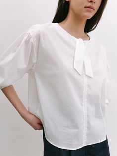 Editor's NotesThis blouse is made of cotton, nylon, and span. It features a dropped shoulder and shirring detail, and a feminine mood. Wear this item with short pants and sandals for a perfect daily look. - Classic design long-sleeve blouse- Relaxed fit and a comfortable fit - Semi-cropped length and volume sleeve- Ribbon detail on the neckline  Measurements(in.)One size (XS-M)- Shoulder: 20.07 in. - Chest: 21.65 in. - Sleeve Length: 20.86 in. - Total Length: 23.62 in. Model Info: Mahina Height 5' 67, Wearing S size  Composition & Care- Shell: 67% Cotton 30% Nylon 3% Span  - Dry Clean Recommended Designer- by LAMINEZ Spring Poplin Tops With Relaxed Fit, Cotton Puff Sleeve Blouse With Tie Sleeves, Cotton Blouse With Tie Sleeves And Puff Sleeve, White Tie Sleeves Top For Daywear, White Blouse With Tie Sleeves For Daywear, White Tops With Tie Sleeves For Daywear, White Casual Poplin Blouse, Chic Poplin Top With Relaxed Fit, Poplin Short Sleeve Workwear Blouse