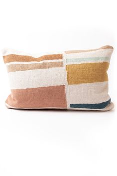 a multicolored striped pillow on a white background