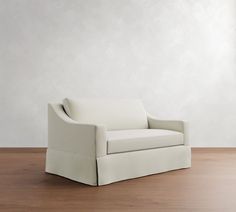 a white chair sitting on top of a wooden floor