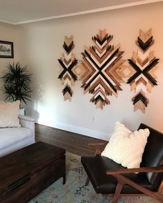 a living room filled with furniture and art pieces on the wall above it's coffee table