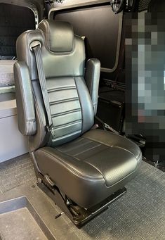 the interior of a vehicle with grey leather seats and gray carpeting on the floor