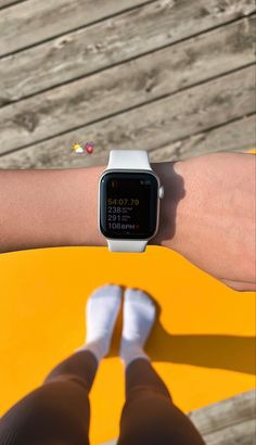 a person wearing a watch on their arm with the screen showing an image of someone's feet