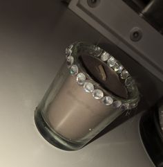 a small glass vase sitting on top of a counter