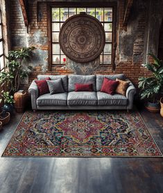 a living room with a couch, rug and potted plants